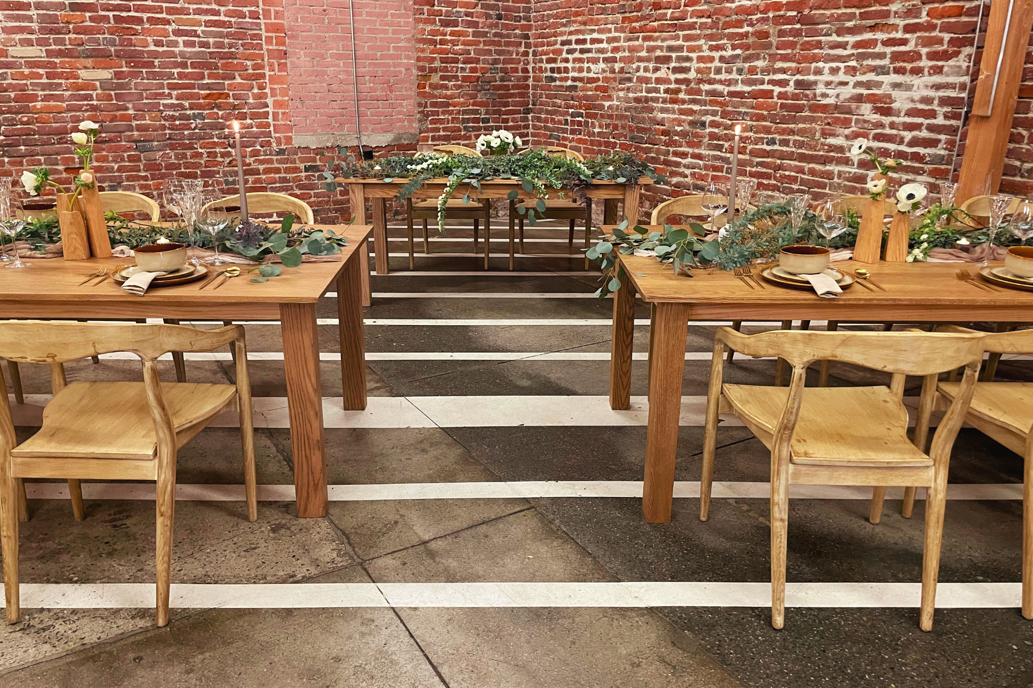 MG Studio Wedding Dinner Tables - brick walls concrete floors wood tables floral tablescape