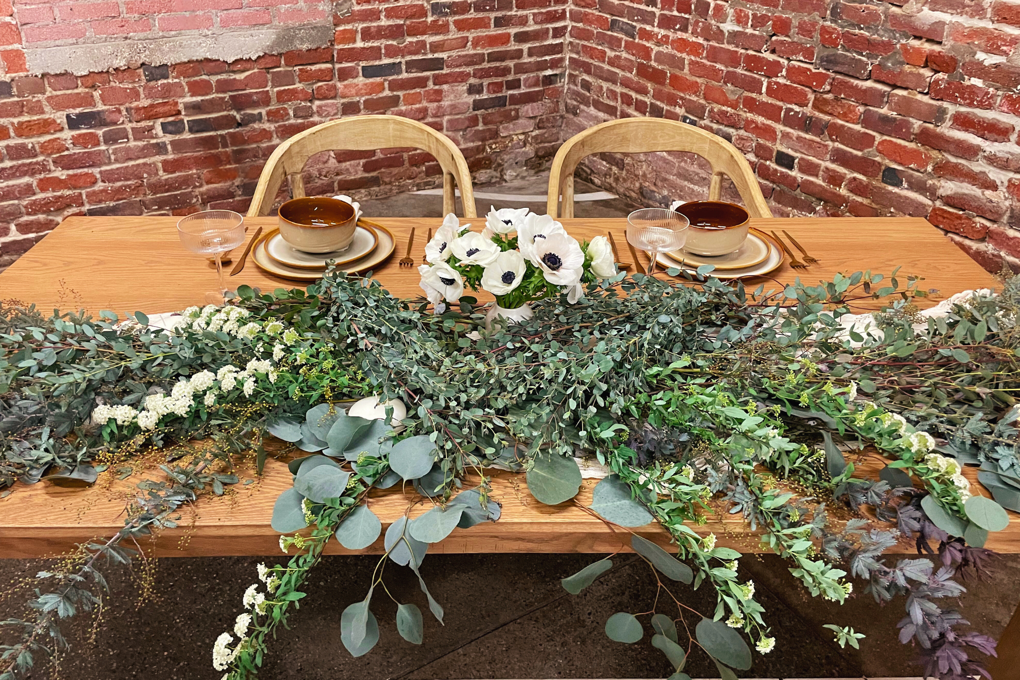 MG Studio Wedding Sweetheart Table - brick walls wood table dinnerware