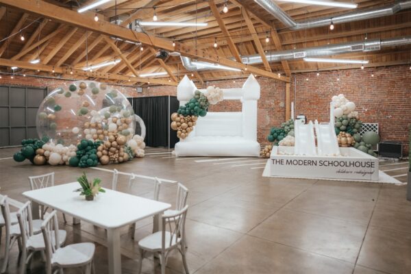 The Modern Schoolhouse white bounce house and ball kit and kids table in Connecticut St. room